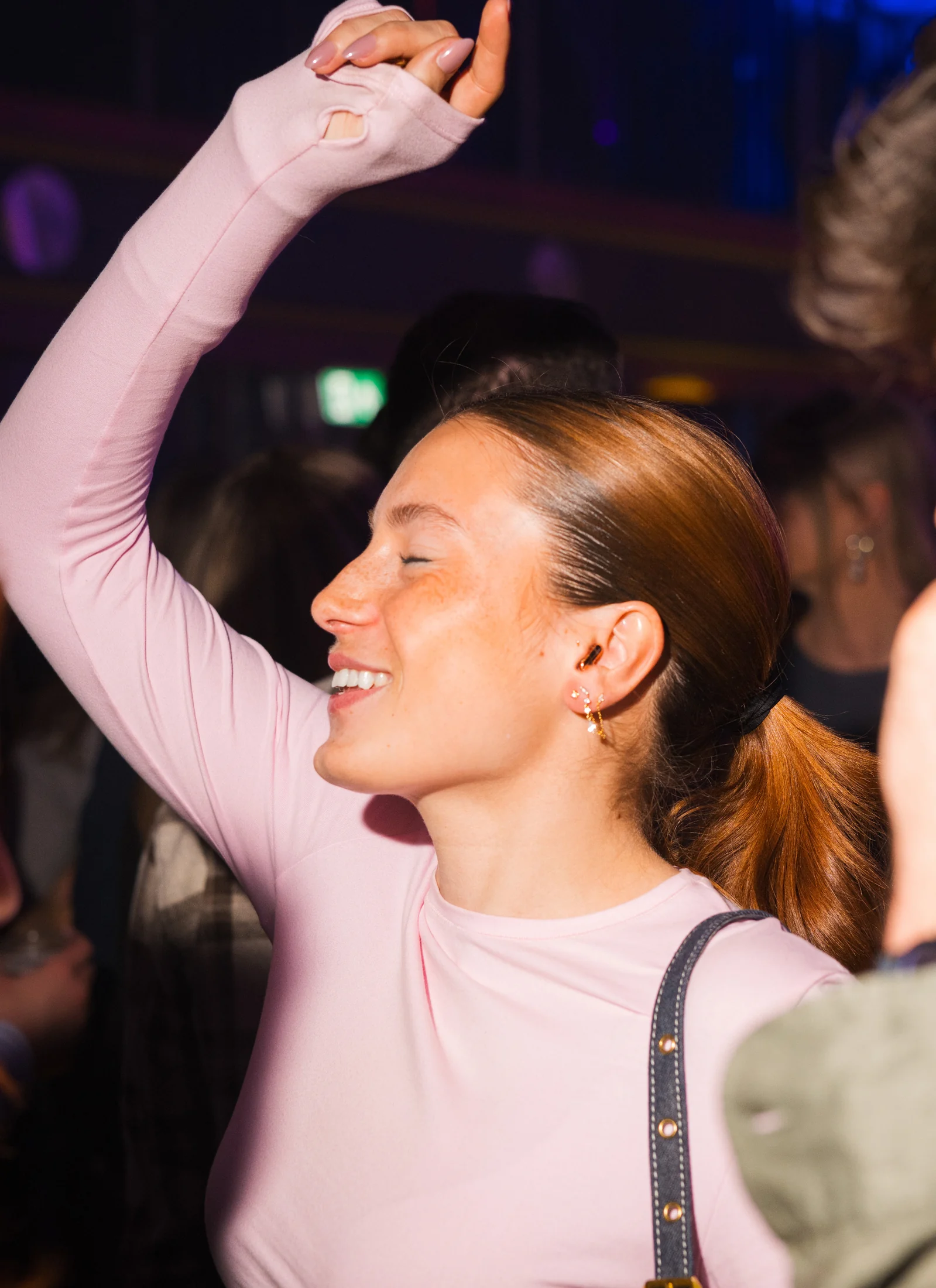 Festival guest wearing Alpine hearing protection at night