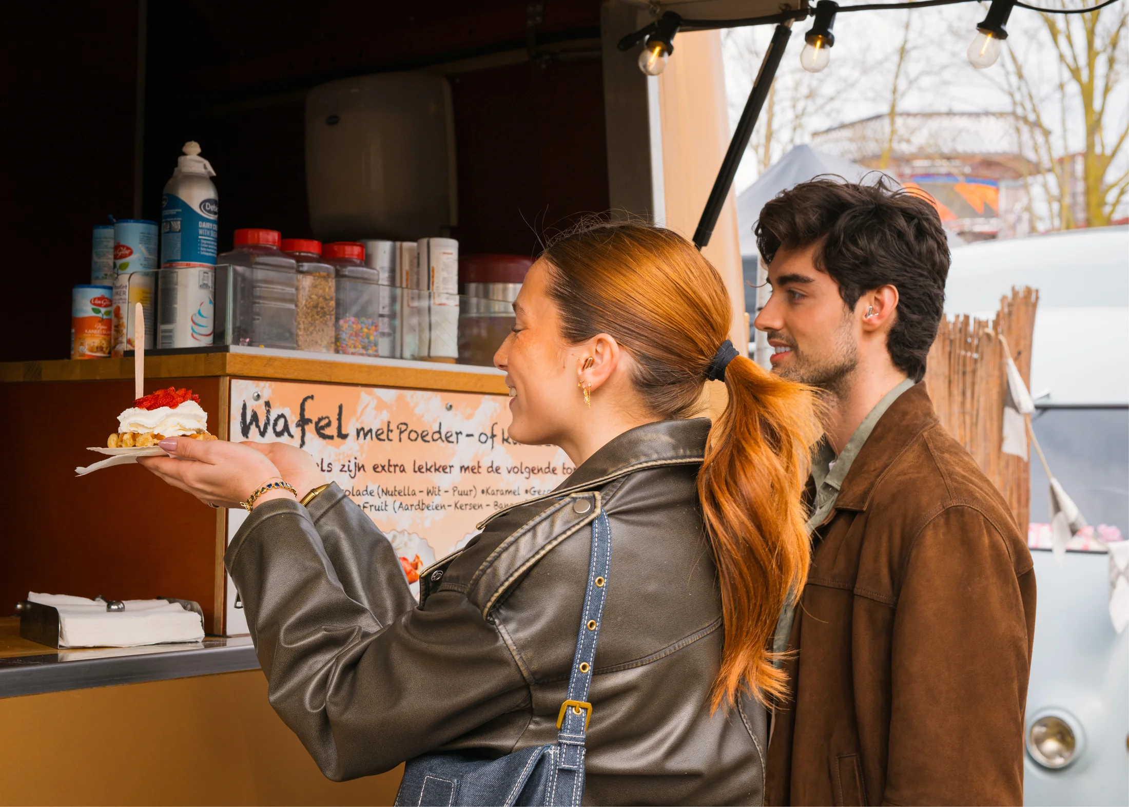 Teaux and a fellow festival visitor collecting a waffle during the Alpine activation